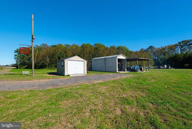 a view of a wooden house with a yard