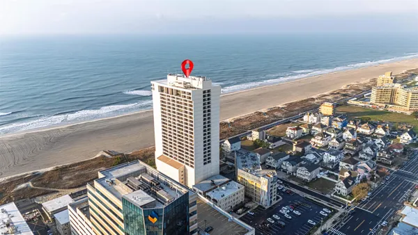 a view of a kitchen with a table and a clock