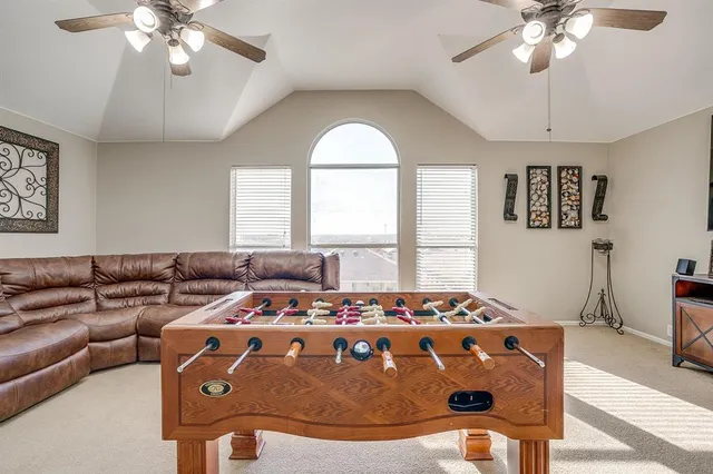 a living room with a large bed and a chandelier