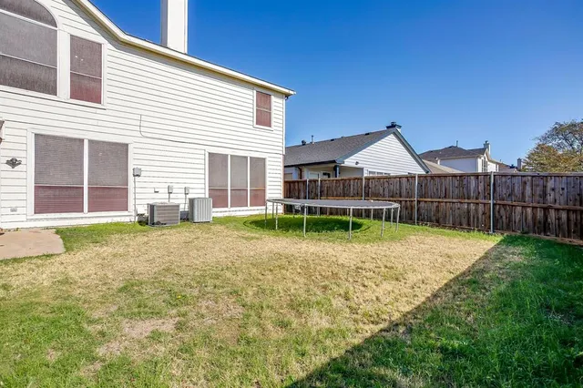 a view of a house with backyard and porch