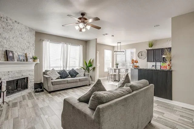 a living room with furniture and fireplace