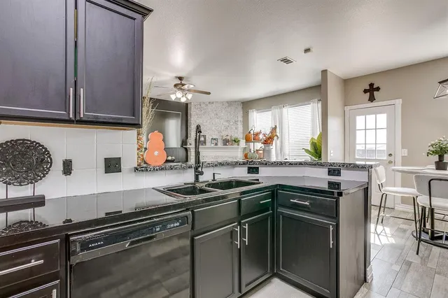a kitchen with stainless steel appliances granite countertop a sink stove and cabinets