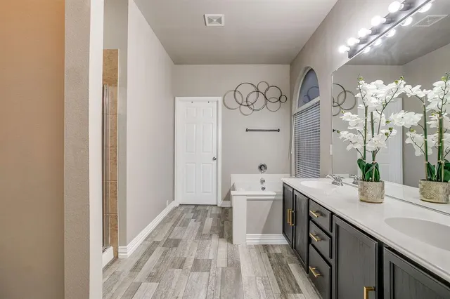 a spacious bathroom with a double vanity sink and a mirror