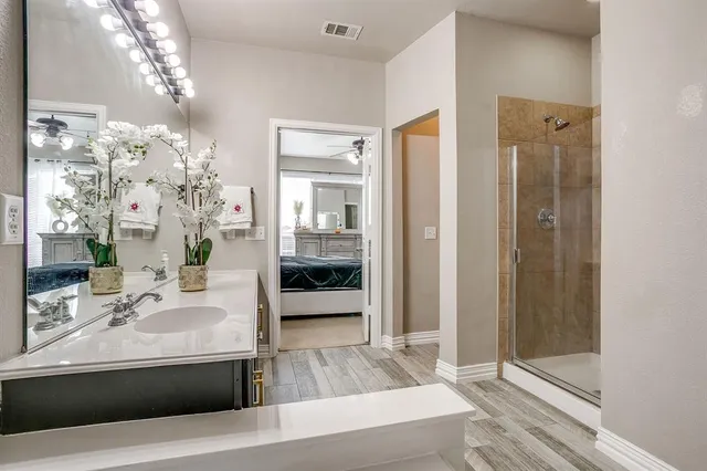 a spacious bathroom with a tub shower and mirror