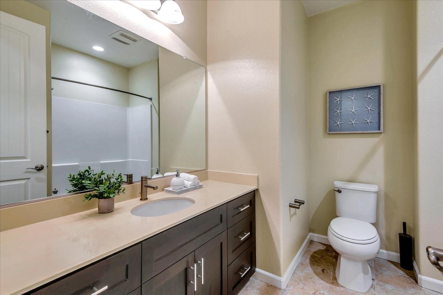 2038 Trento Loop Milpitas, CA 95035 - Photo 16 of 22 a bathroom with a sink a toilet and mirror