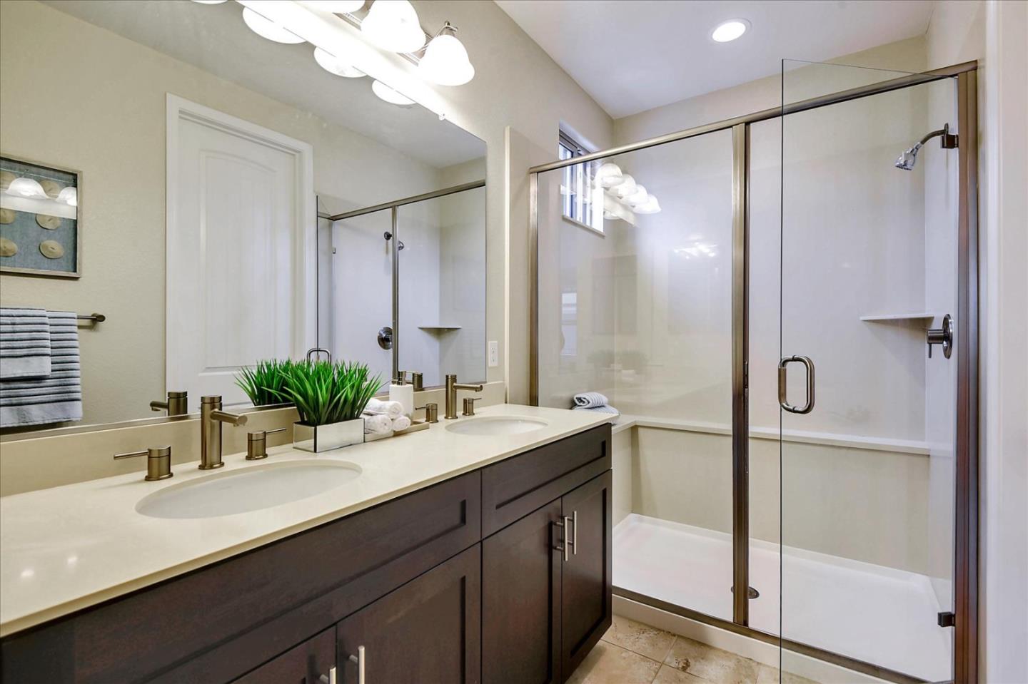 2038 Trento Loop Milpitas, CA 95035 - Photo 17 of 22 a bathroom with a double vanity sink mirror and shower