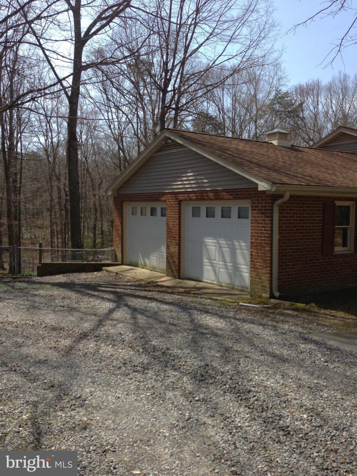 7602 River Road Fredericksburg, VA 22407 - Photo 4 of 7 a front view of a house with a yard and garage