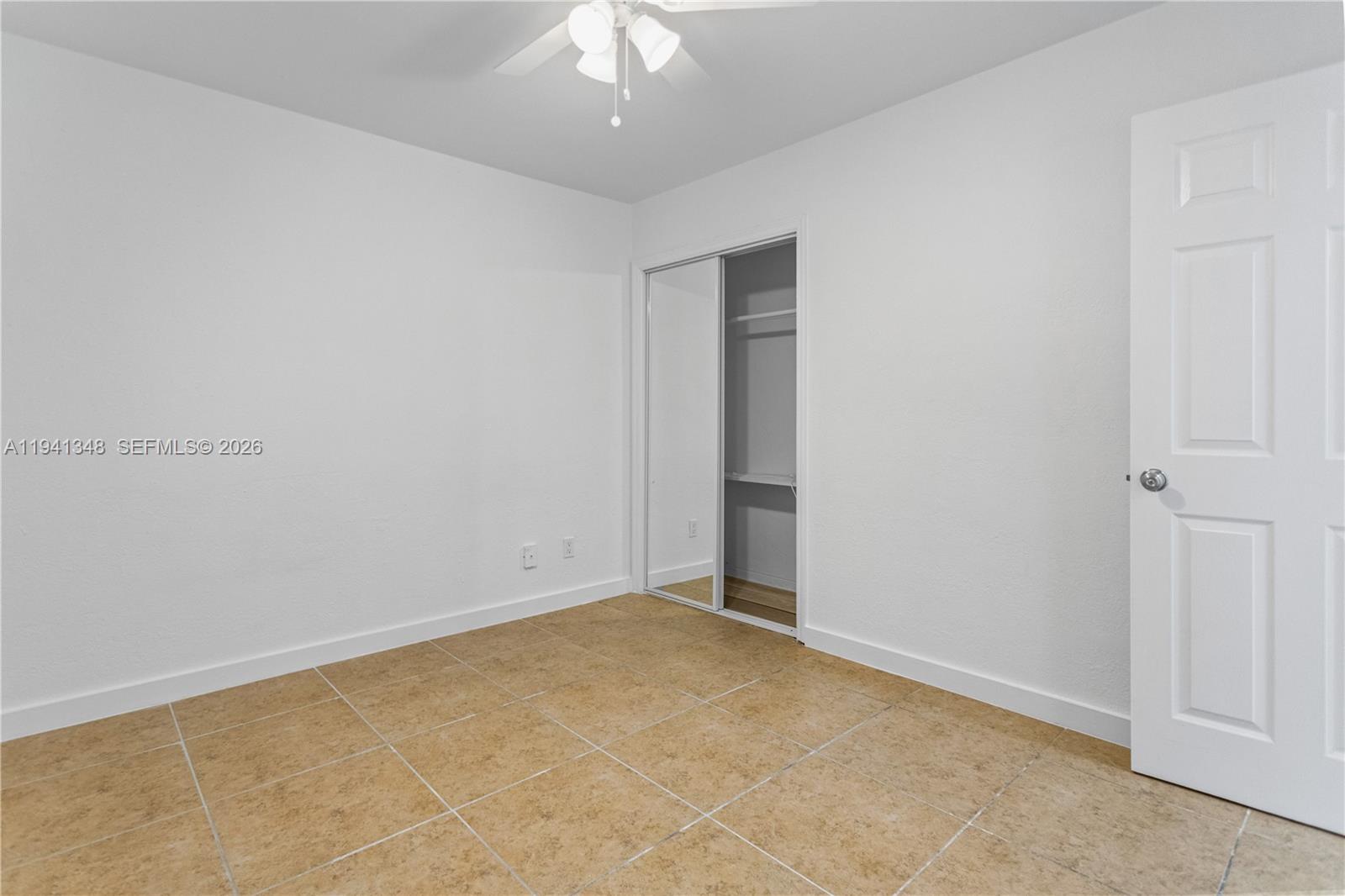 3253 Pierce Street Hollywood, FL 33021 - Photo 14 of 53 an empty room with a ceiling fan