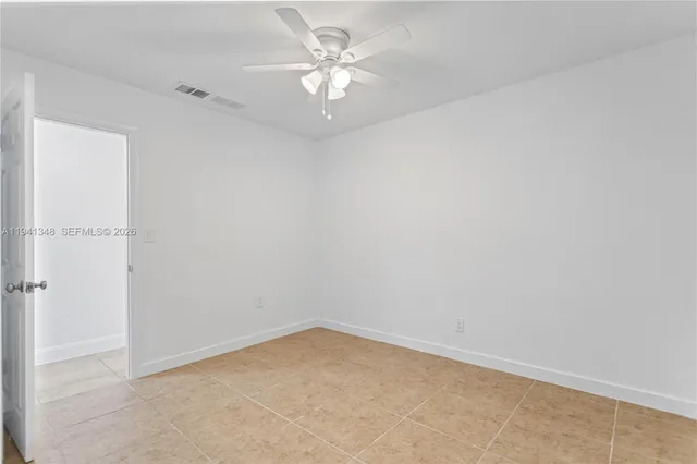 an empty room with closet and mirror