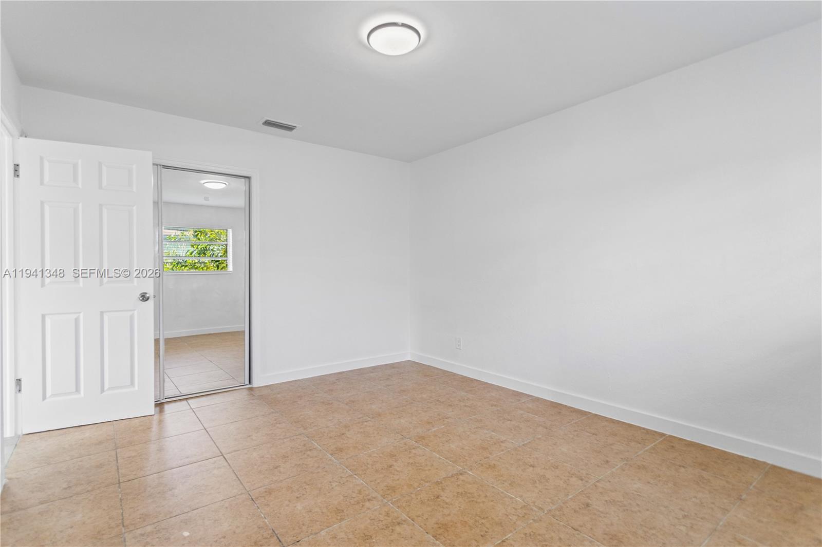 3253 Pierce Street Hollywood, FL 33021 - Photo 17 of 53 an empty room with closet and mirror