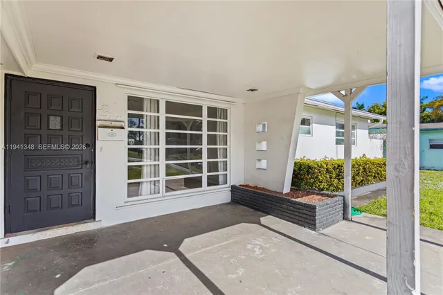 a swimming pool with yard in front of it