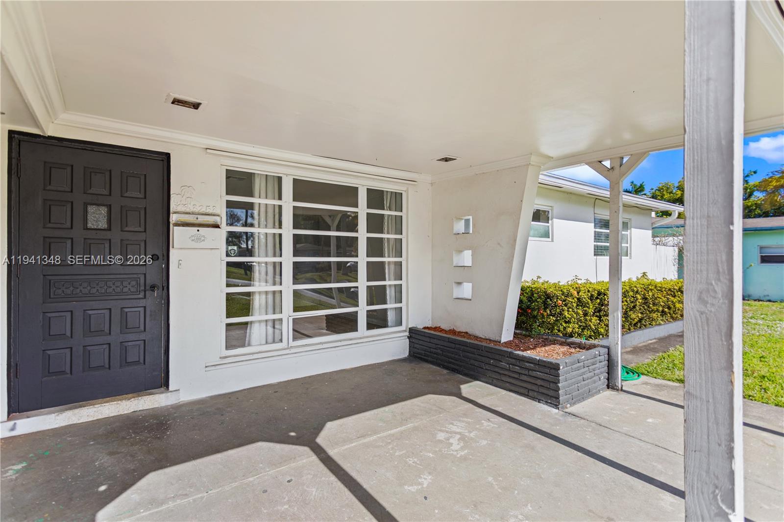 3253 Pierce Street Hollywood, FL 33021 - Photo 24 of 53 a view of a porch with wooden floor and front door