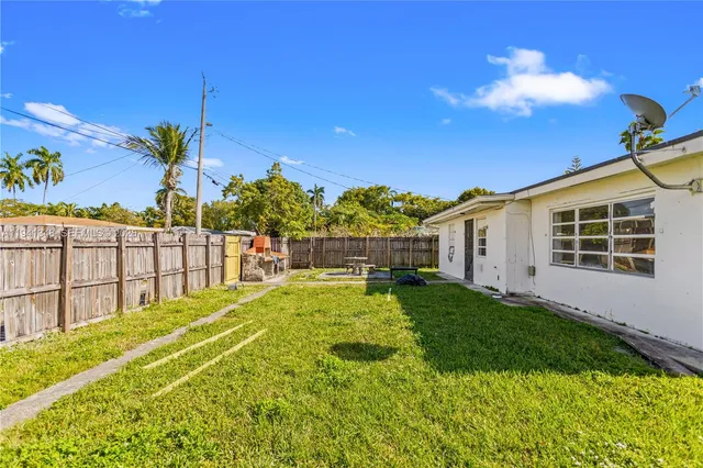 a view of a backyard with plants and patio