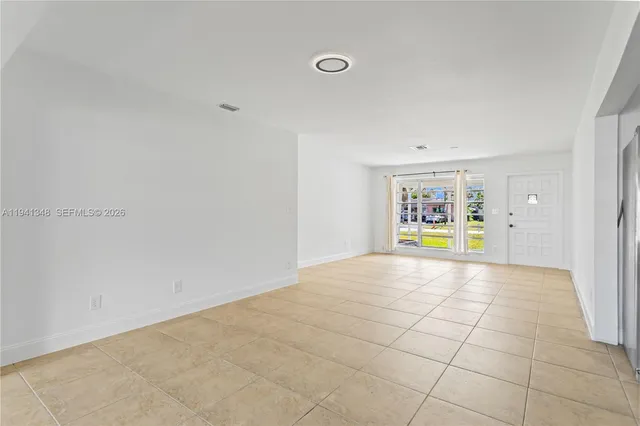 a view of empty room with a fireplace