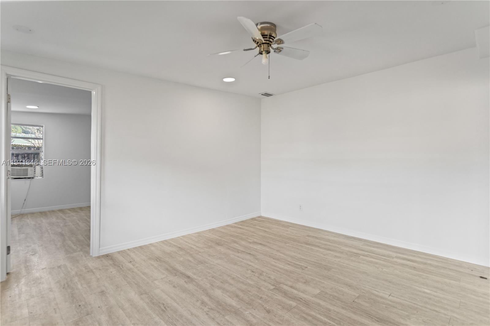 3253 Pierce Street Hollywood, FL 33021 - Photo 37 of 53 wooden floor in an empty room with a window