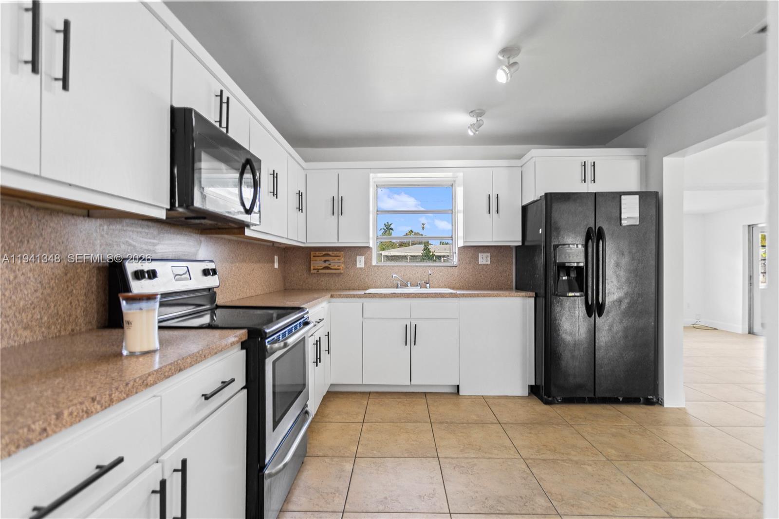 3253 Pierce Street Hollywood, FL 33021 - Photo 4 of 53 a kitchen with stainless steel appliances granite countertop a refrigerator and a stove top oven