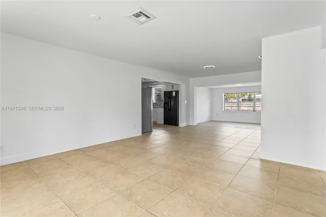 a view of an empty room and a window
