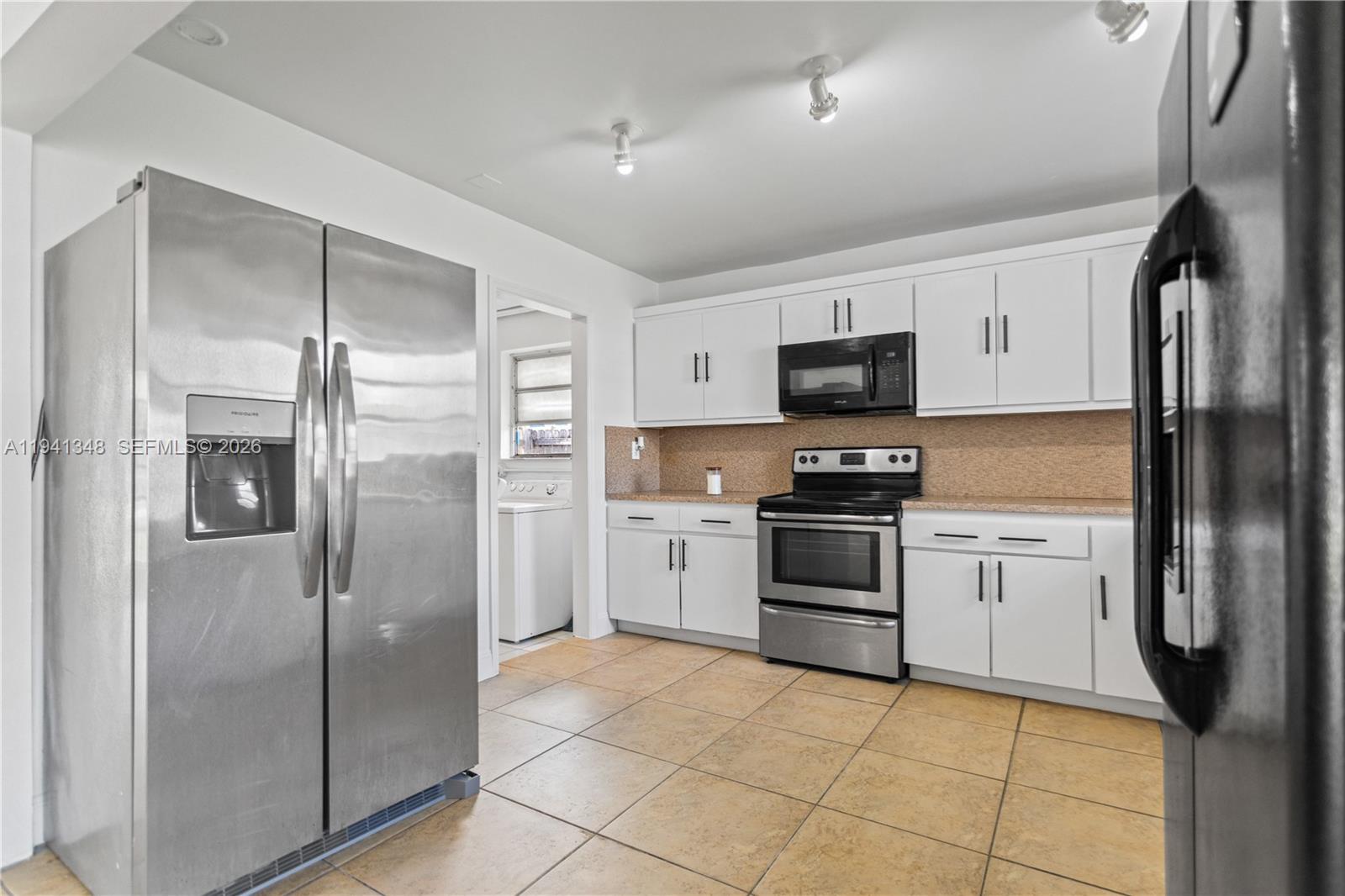3253 Pierce Street Hollywood, FL 33021 - Photo 6 of 53 a kitchen with stainless steel appliances granite countertop a refrigerator and a stove top oven