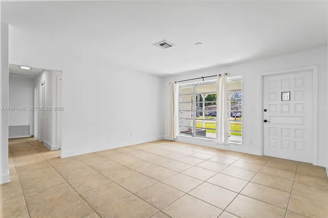 a view of a kitchen with a sink and a window
