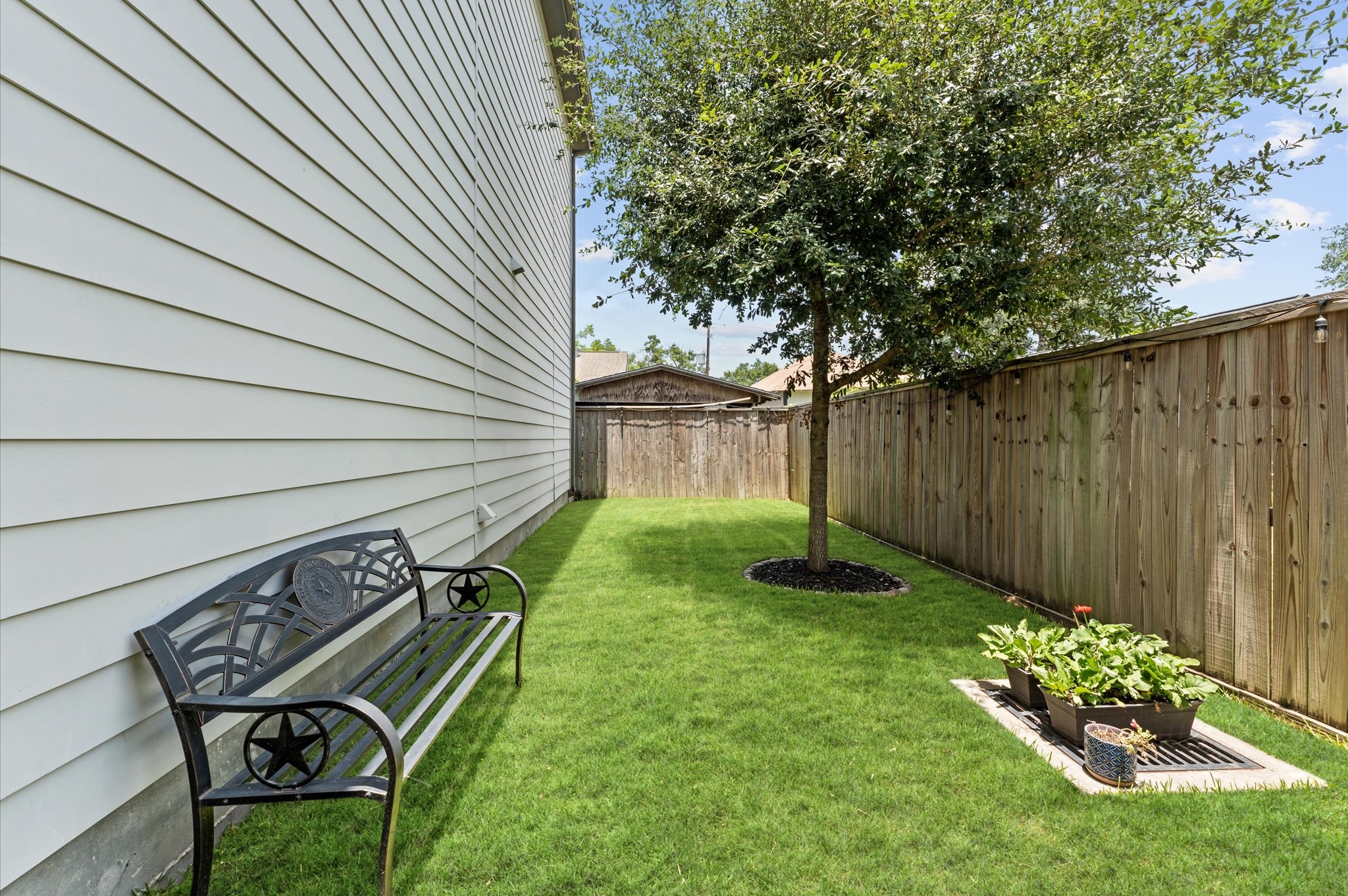2422 Cochran Street Houston, TX 77009 - Photo 4 of 31 A charming side yard, complete with a shade tree, is a great area for a little outdoor relaxation. Pets allowed on a case-by-case basis.
