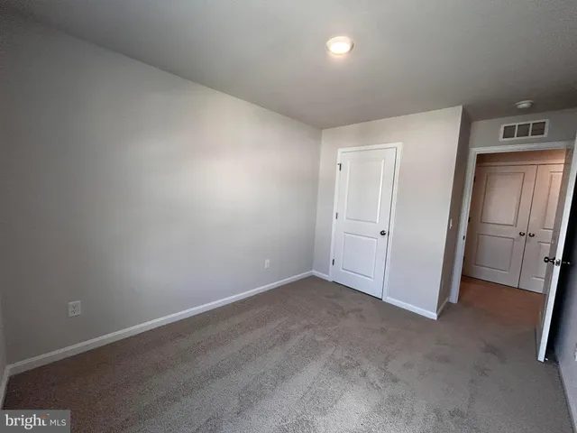 an empty room with a mirror