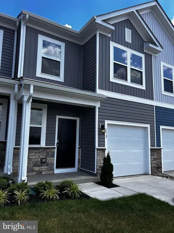 a view of a house with many windows and a yard
