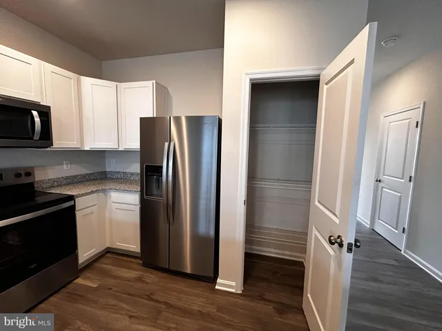 a kitchen with stainless steel appliances a refrigerator and a sink