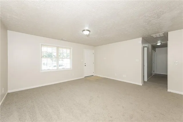 an empty room with a empty space and windows