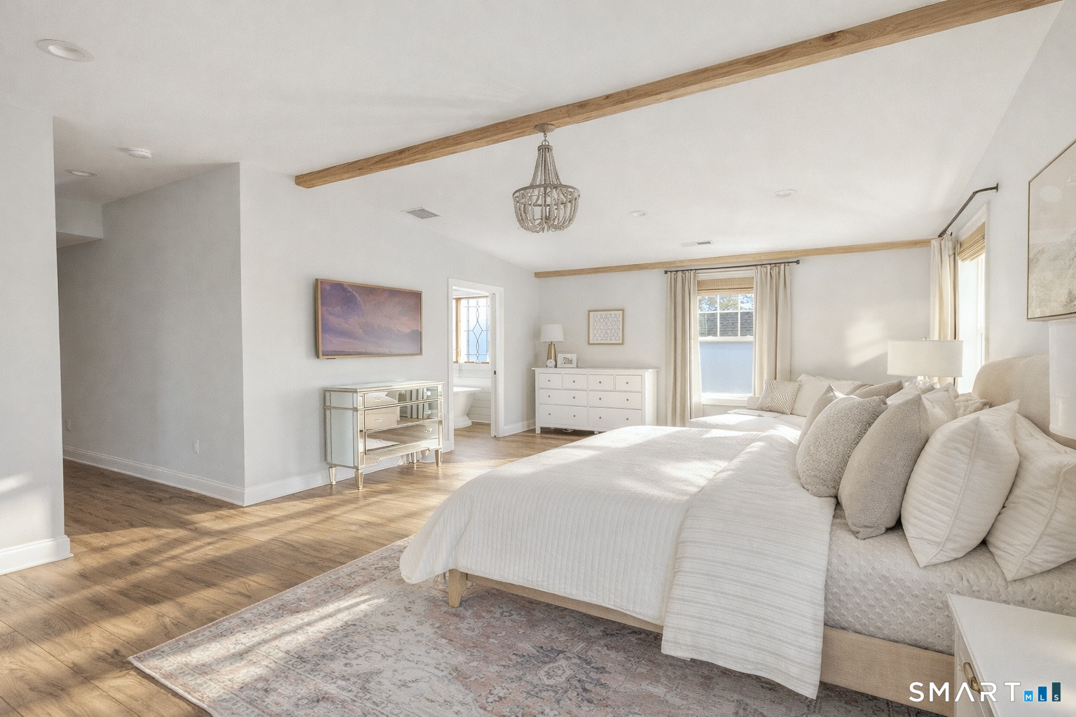 34 Orchard Road Milford, CT 06460 - Photo 13 of 25 a bedroom with a bed and wooden floor