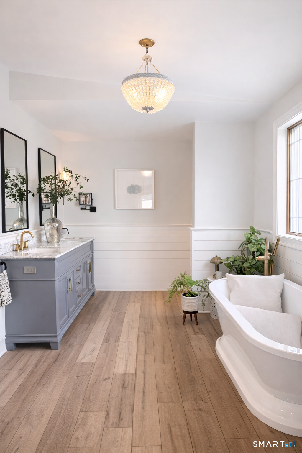 34 Orchard Road Milford, CT 06460 - Photo 14 of 25 a spacious bathroom with a bathtub double sink and a mirror