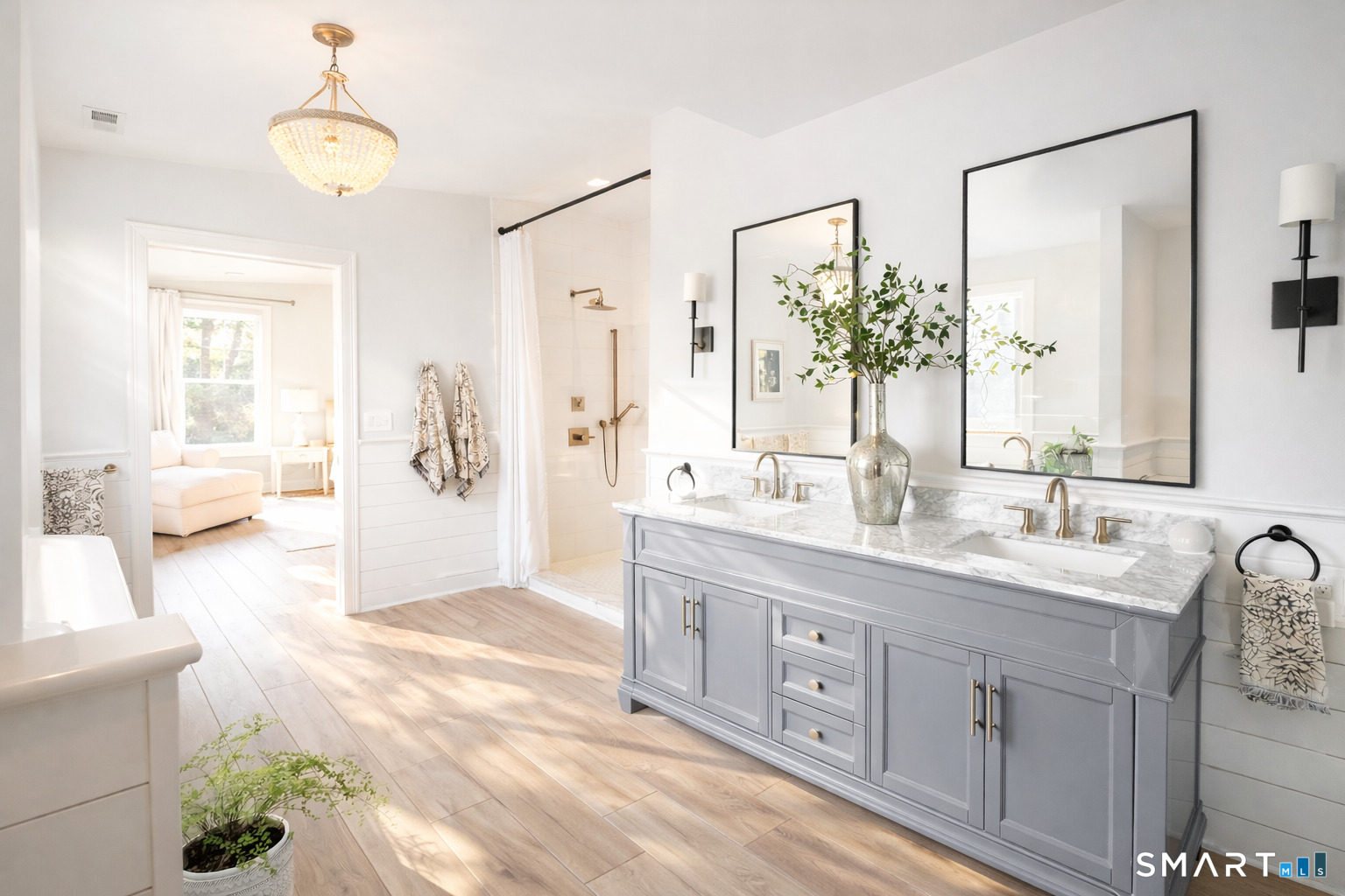 34 Orchard Road Milford, CT 06460 - Photo 17 of 25 a spacious bathroom with double vanity a mirror a vanity and a shower