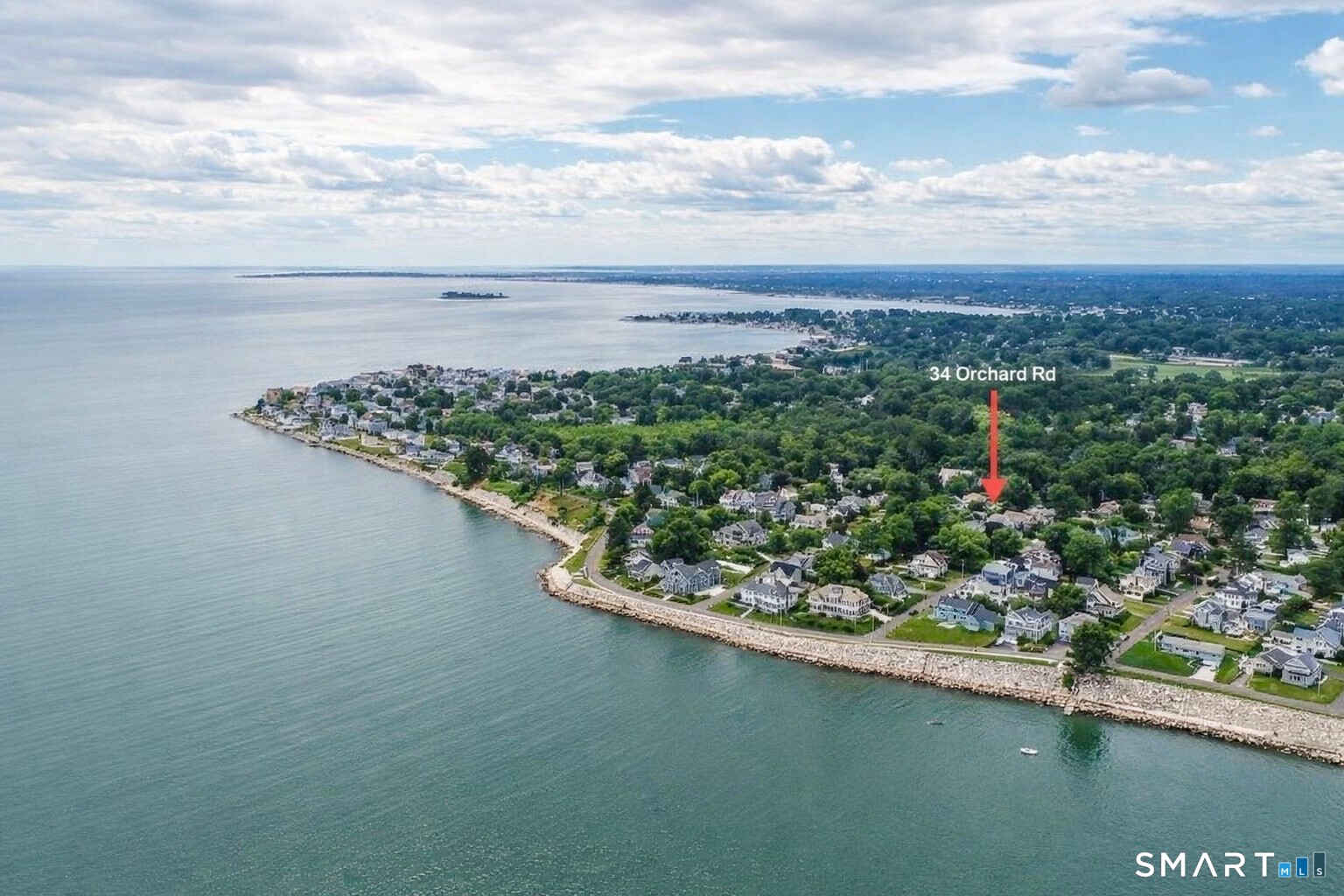 34 Orchard Road Milford, CT 06460 - Photo 2 of 25 a view of a lake with a house in the background