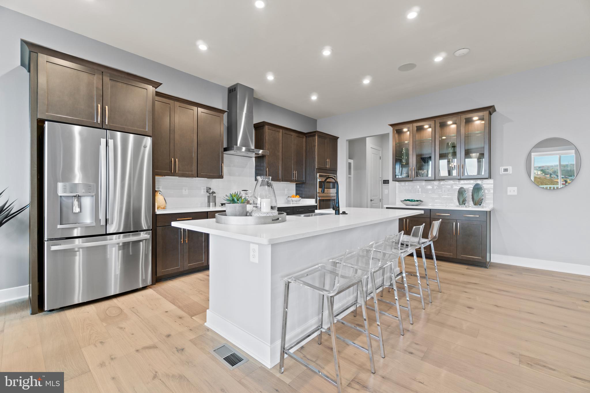 a kitchen with kitchen island a counter top space a sink stainless steel appliances and cabinets