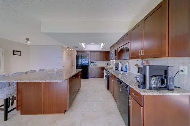 a view of kitchen with sink microwave and stove