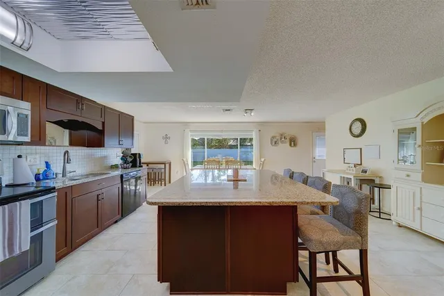 a room with furniture a flat screen tv and a sink