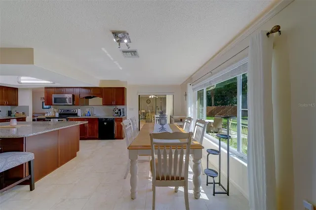 a large kitchen with a table and chairs