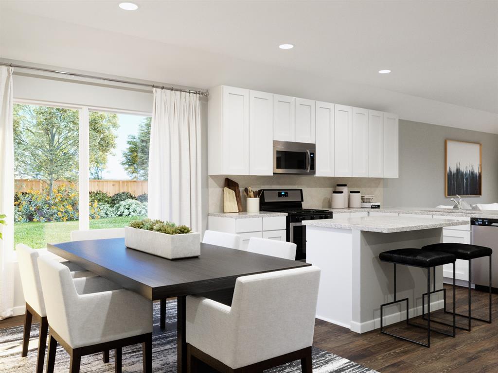 1104 Runway Road Fort Worth, TX 76131 - Photo 19 of 36 a kitchen with a table chairs microwave and cabinets