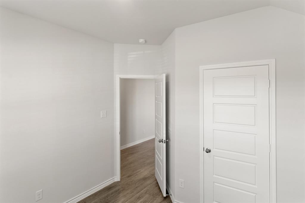 1104 Runway Road Fort Worth, TX 76131 - Photo 4 of 36 a view of a hallway with wooden floor