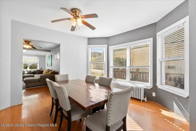a view of a dining room with furniture window and wooden floor