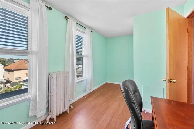 a view of workspace with wooden floor and windows