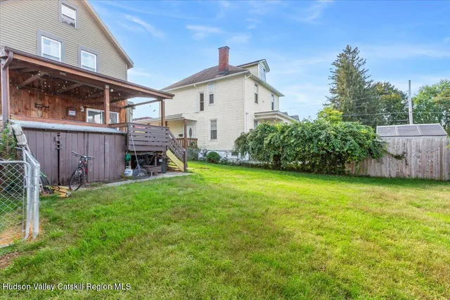 a view of a house with a yard and a garden