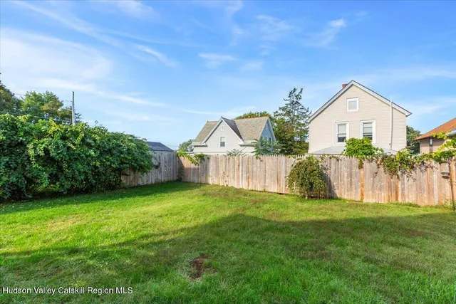 an aerial view of a house with a garden and swimming pool