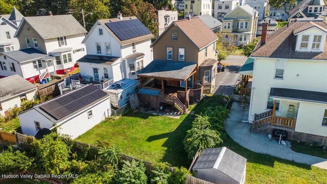 an aerial view of a house with a yard