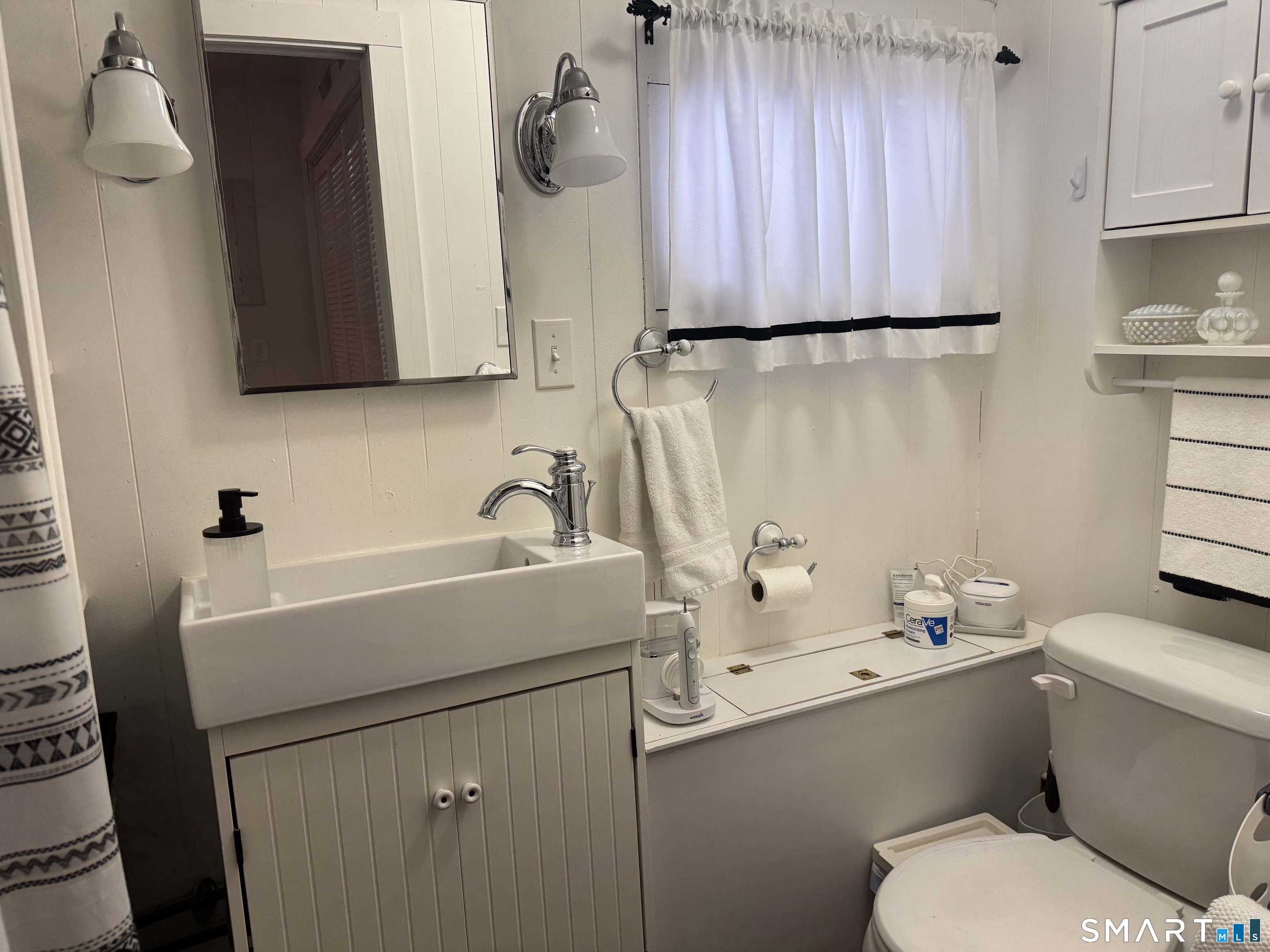 15 Brickyard Road Clinton, CT 06413 - Photo 71 of 86 a bathroom with a sink a toilet and mirror