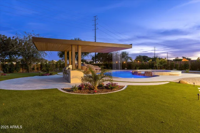 a kitchen with stainless steel appliances kitchen island granite countertop a table chairs stove and refrigerator