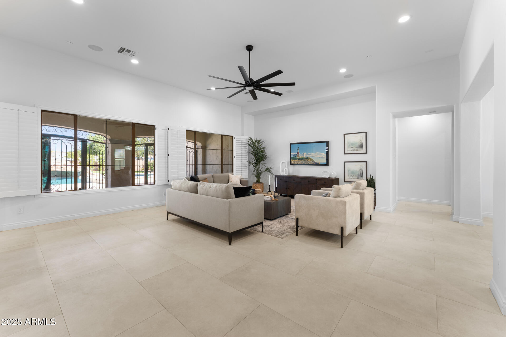 4547 South Banning Drive Gilbert, AZ 85297 - Photo 14 of 45 a living room with furniture and a chandelier