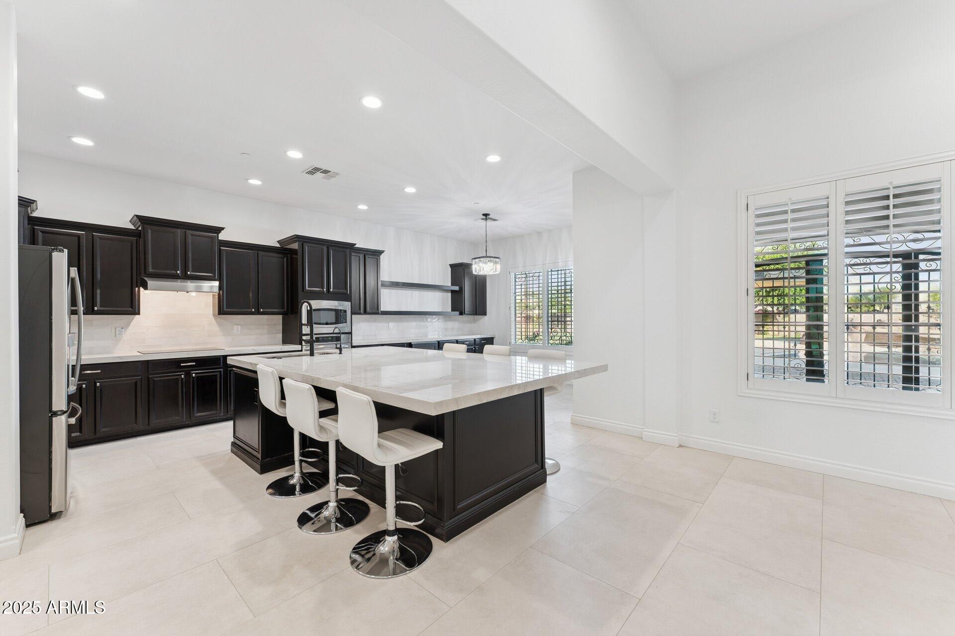 4547 South Banning Drive Gilbert, AZ 85297 - Photo 17 of 45 a large white kitchen with a large window