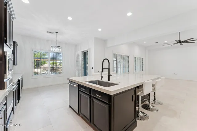 a spacious bathroom with a tub sink and mirror