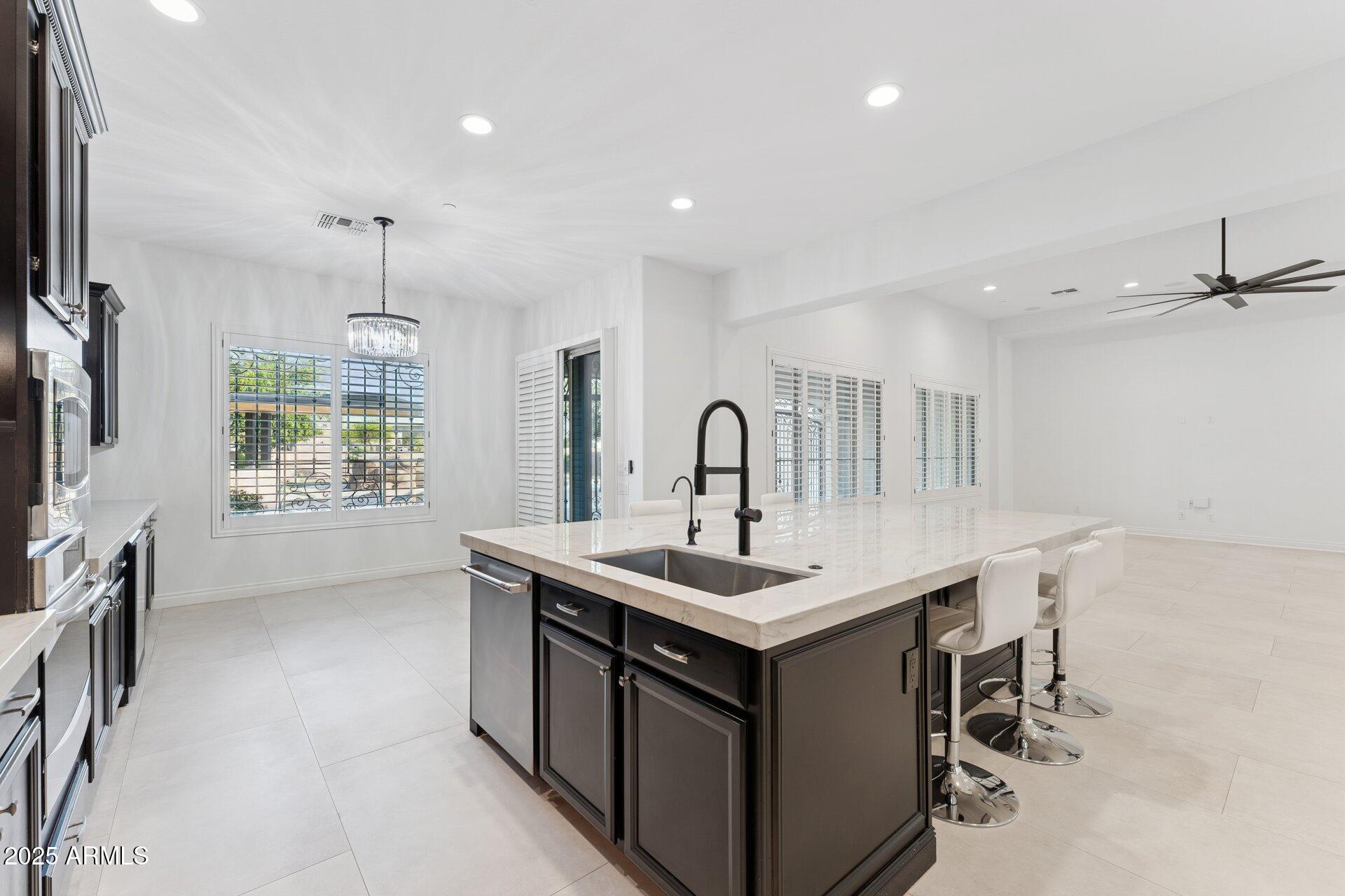 4547 South Banning Drive Gilbert, AZ 85297 - Photo 20 of 45 a kitchen with a sink appliances and a counter top space