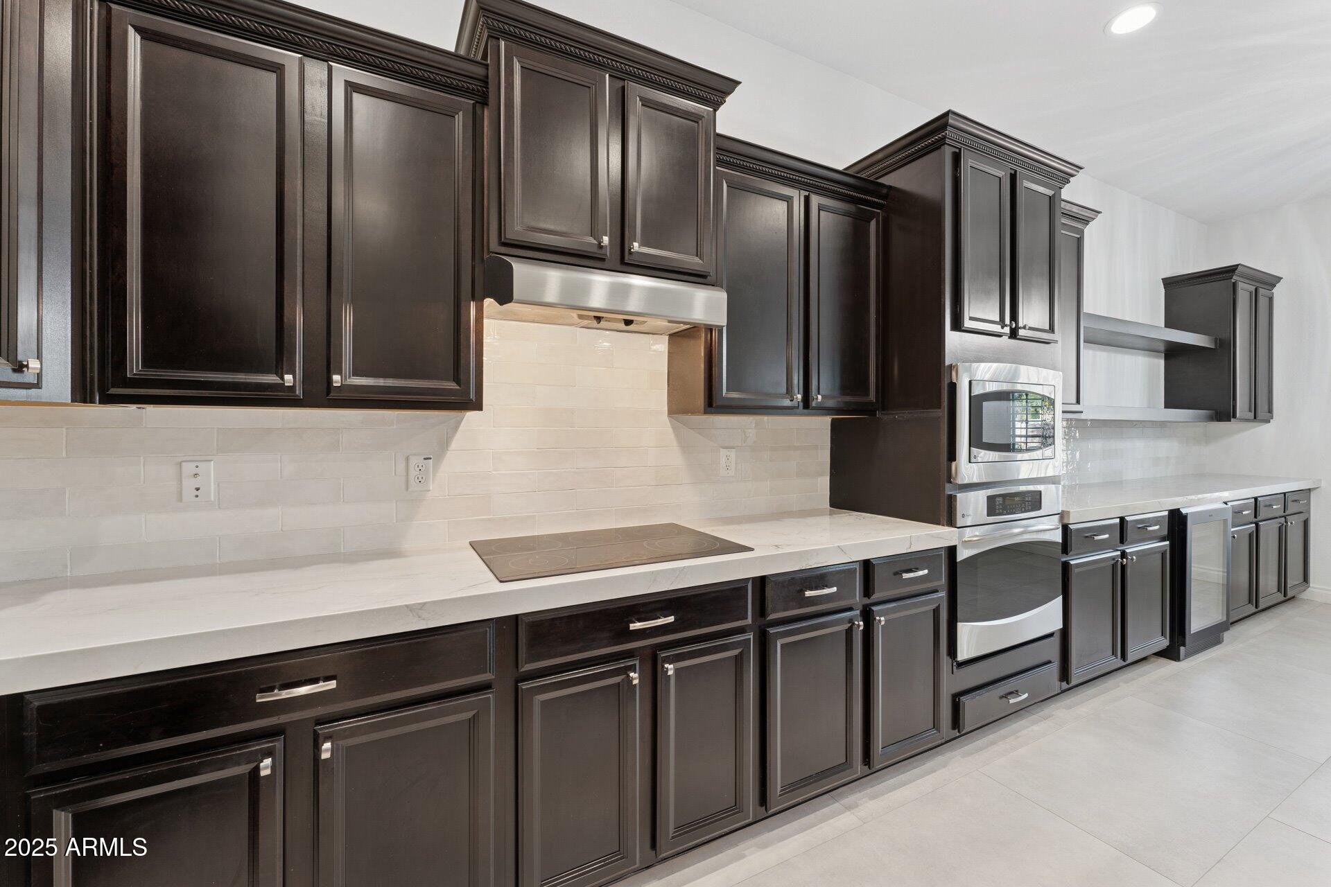 4547 South Banning Drive Gilbert, AZ 85297 - Photo 21 of 45 a kitchen with stainless steel appliances and wood cabinets